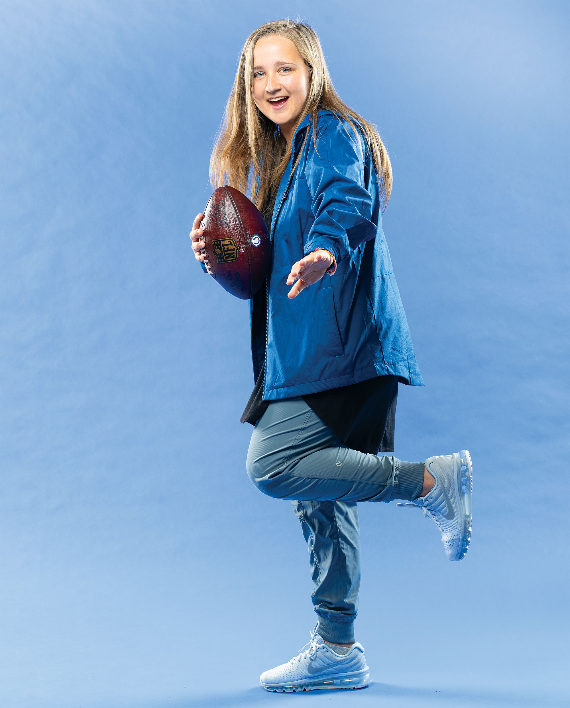 Kasia Omilian holds a football.