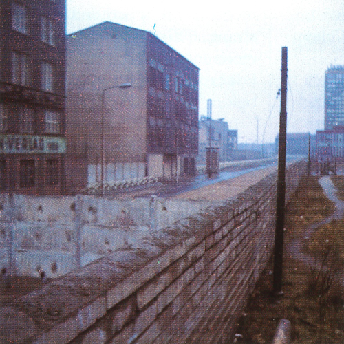 The Berlin Wall with empty city streets in the background