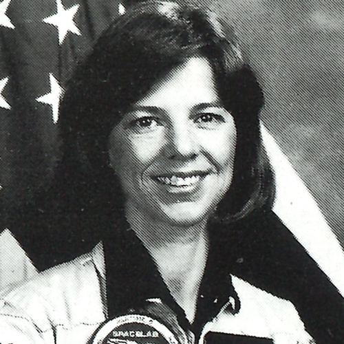 Black and white film headshot of Bonnie Dunbar in astronaut uniform