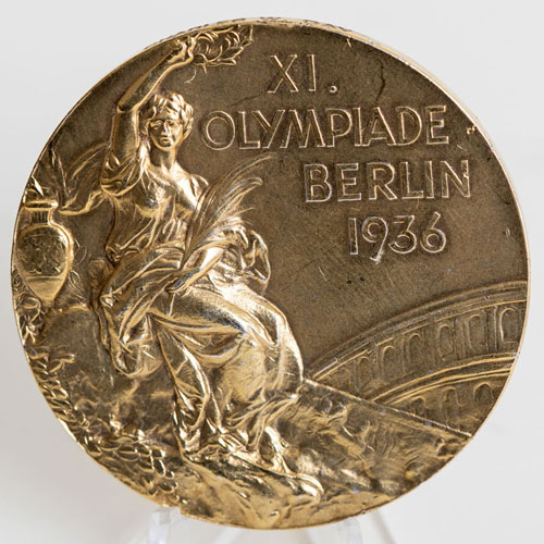 A gold Olympic medal that reads "XI OLYMPIADE BERLIN 1936"