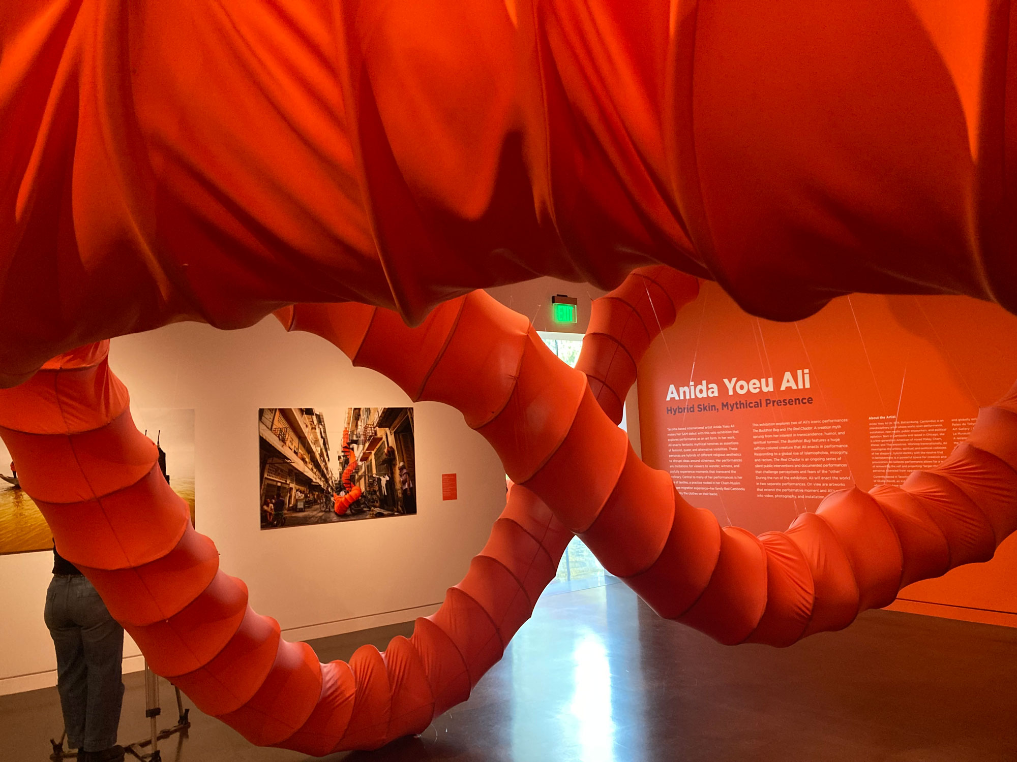 A large orange tube winds its way through a museum exhibit