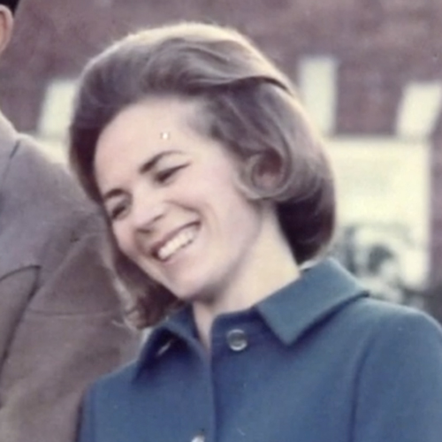 A close up of a woman smiling in a vintage family photo