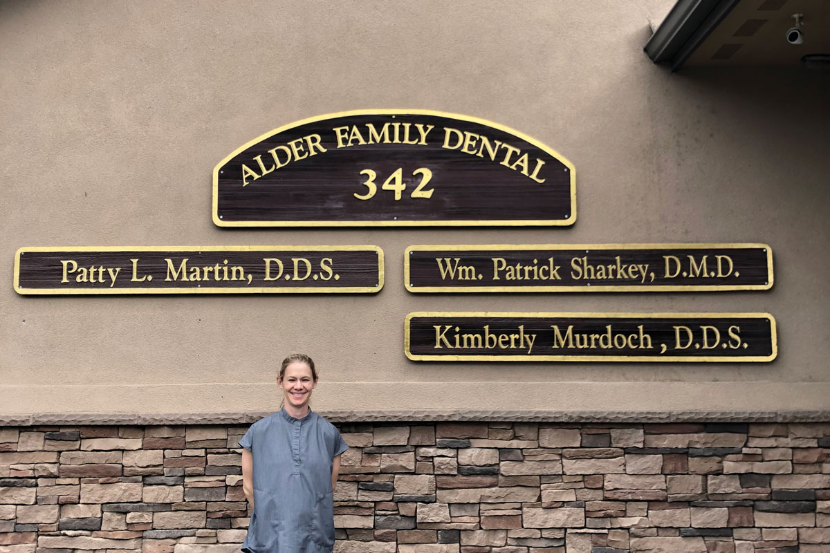 A woman in scrubs stands in front of a sign that says "Walla Walla Dental," then lists the names of the dentists, including Patty Martin D.D.S.