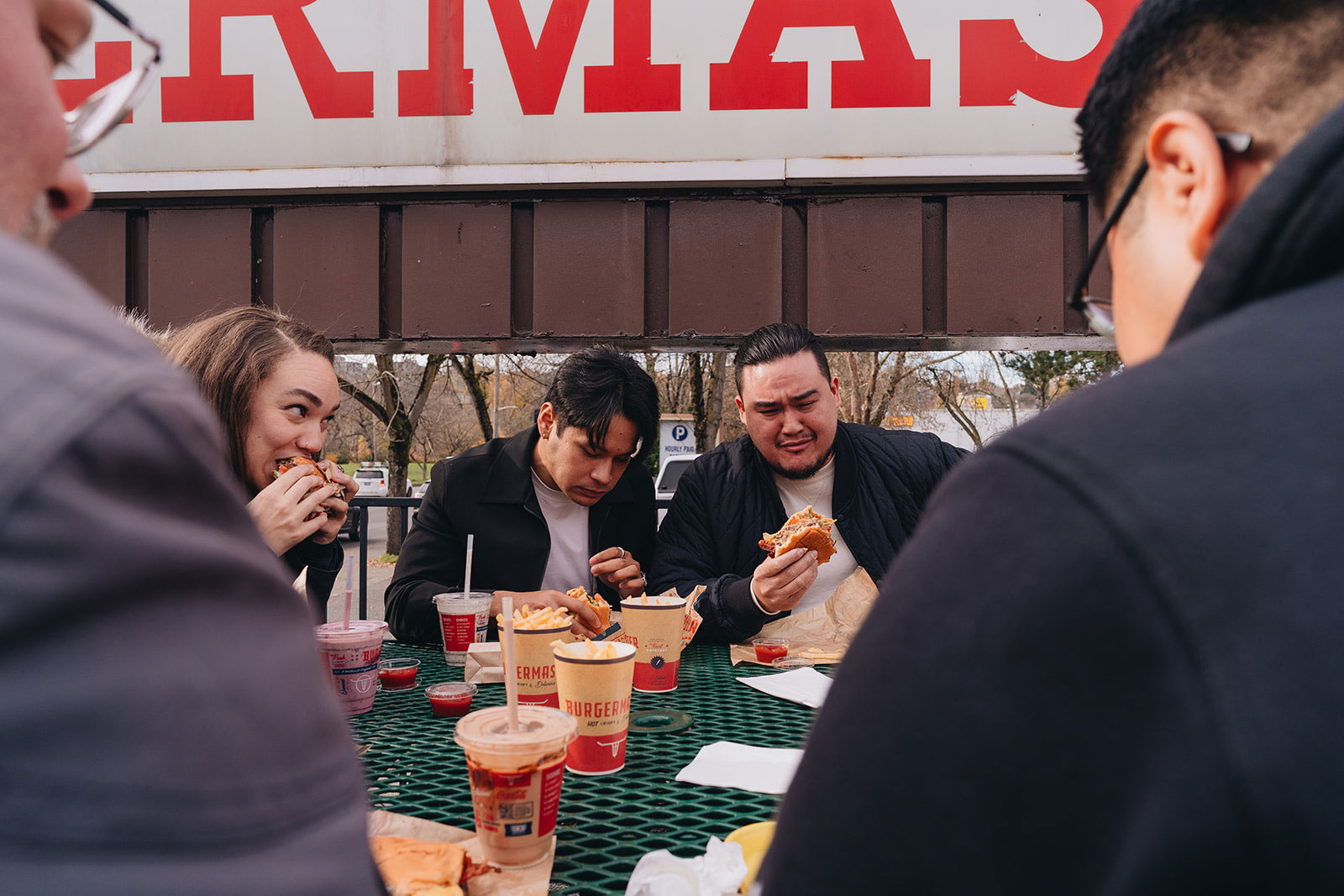 People laugh, cry and eat at the outdoor tables outside Burgermaster.