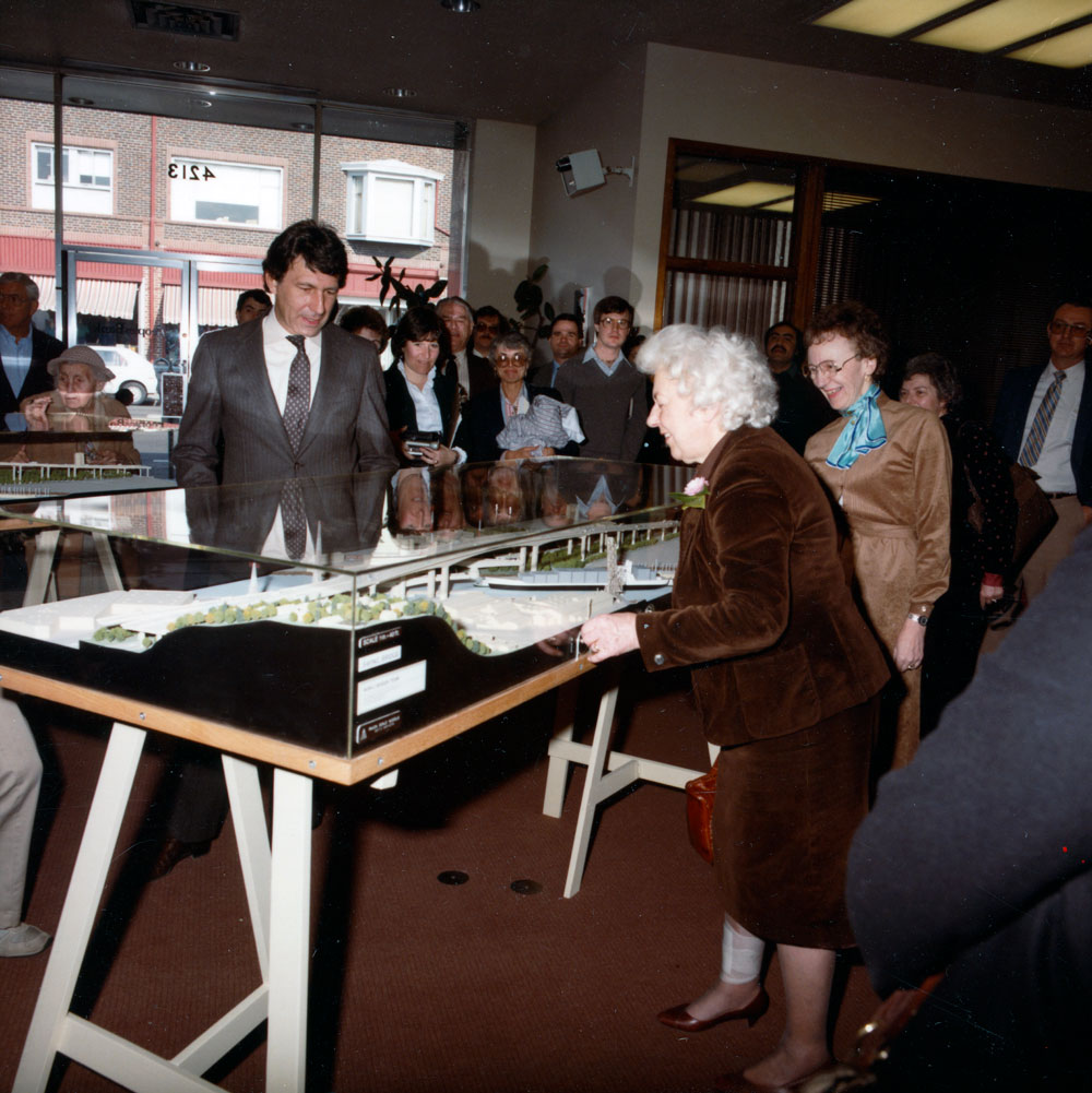 Jeanette Williams examines a model of the West Seattle Bridge encased in glass