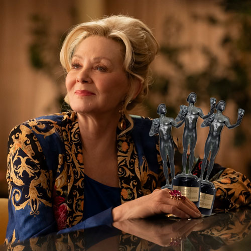 Jean Smart smiles at a bar with three SAG awards digitally added in her hands