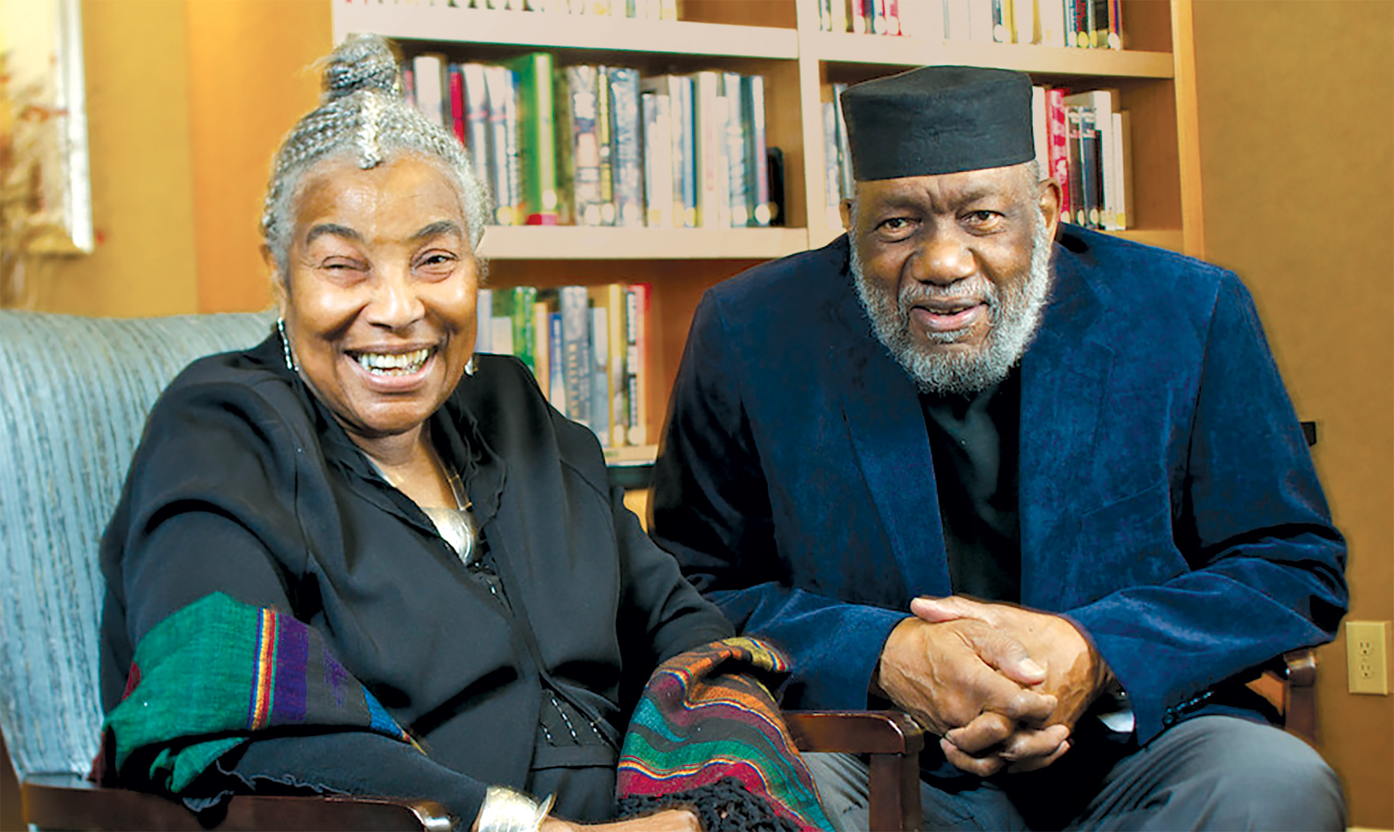 Lois and Thaddeus Spratlen sitting and smiling wearing formal attire