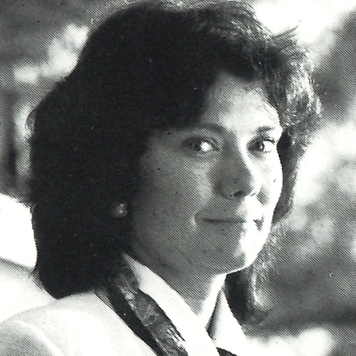 Headshot of Judith Patterson from the shoulders up wearing a white blazer
