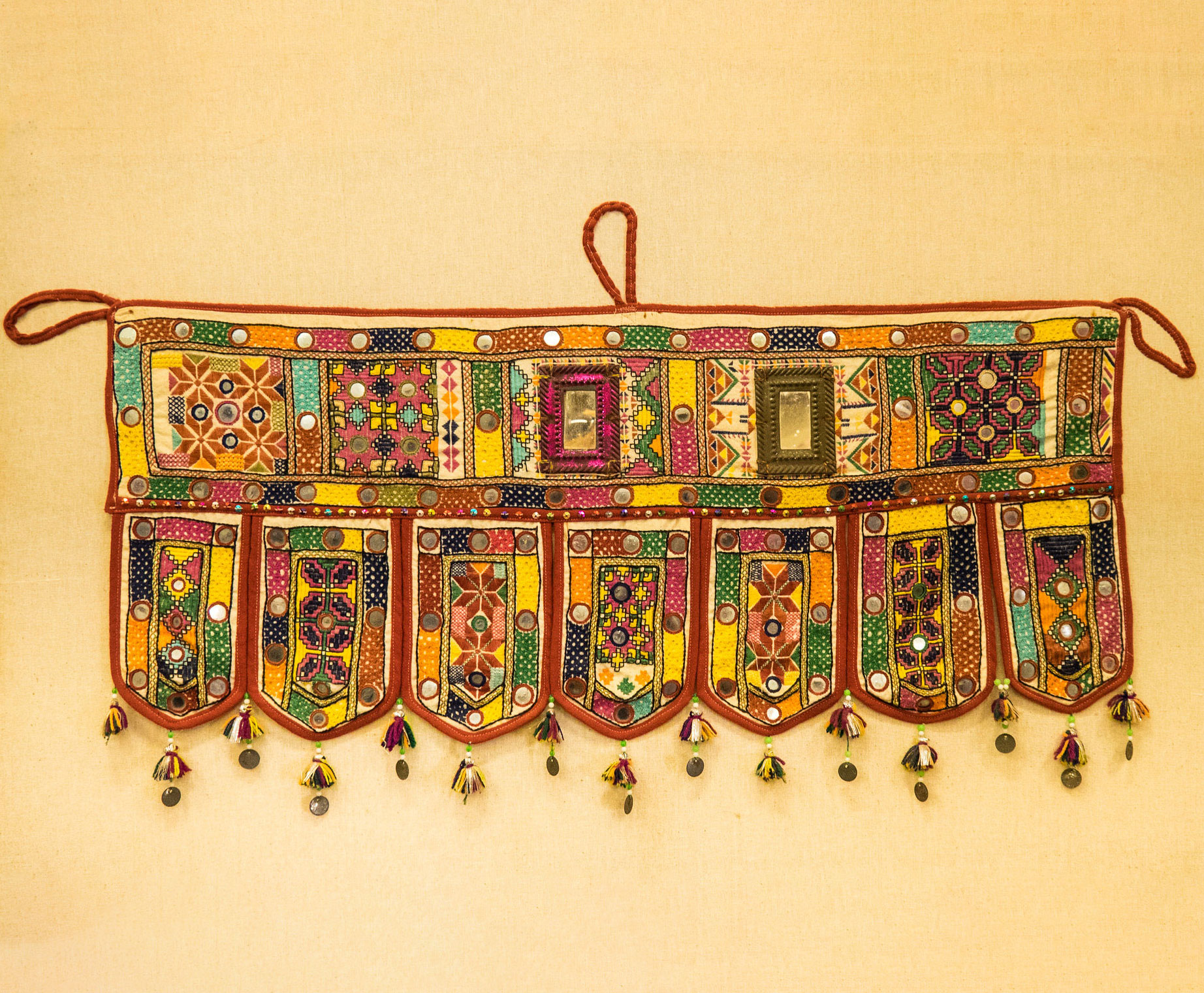 Embroidered wall hanging with leaf-shaped hanging fabric