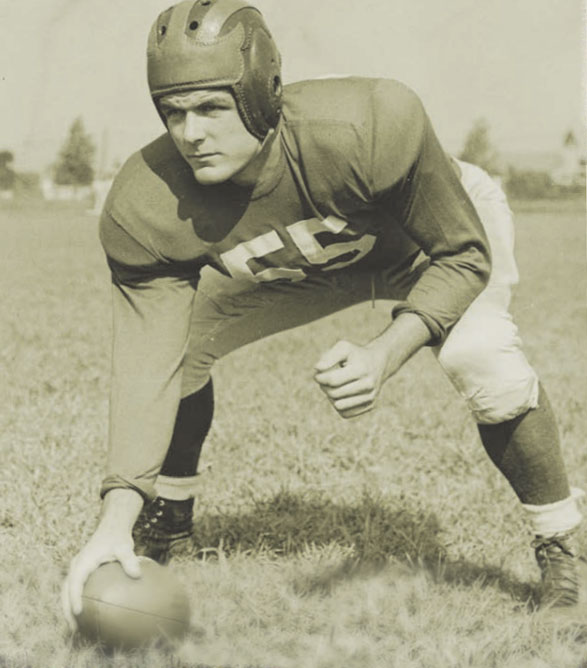 Sepia toned photograph from 1948 of Carl Fennema playing football in a grassy field