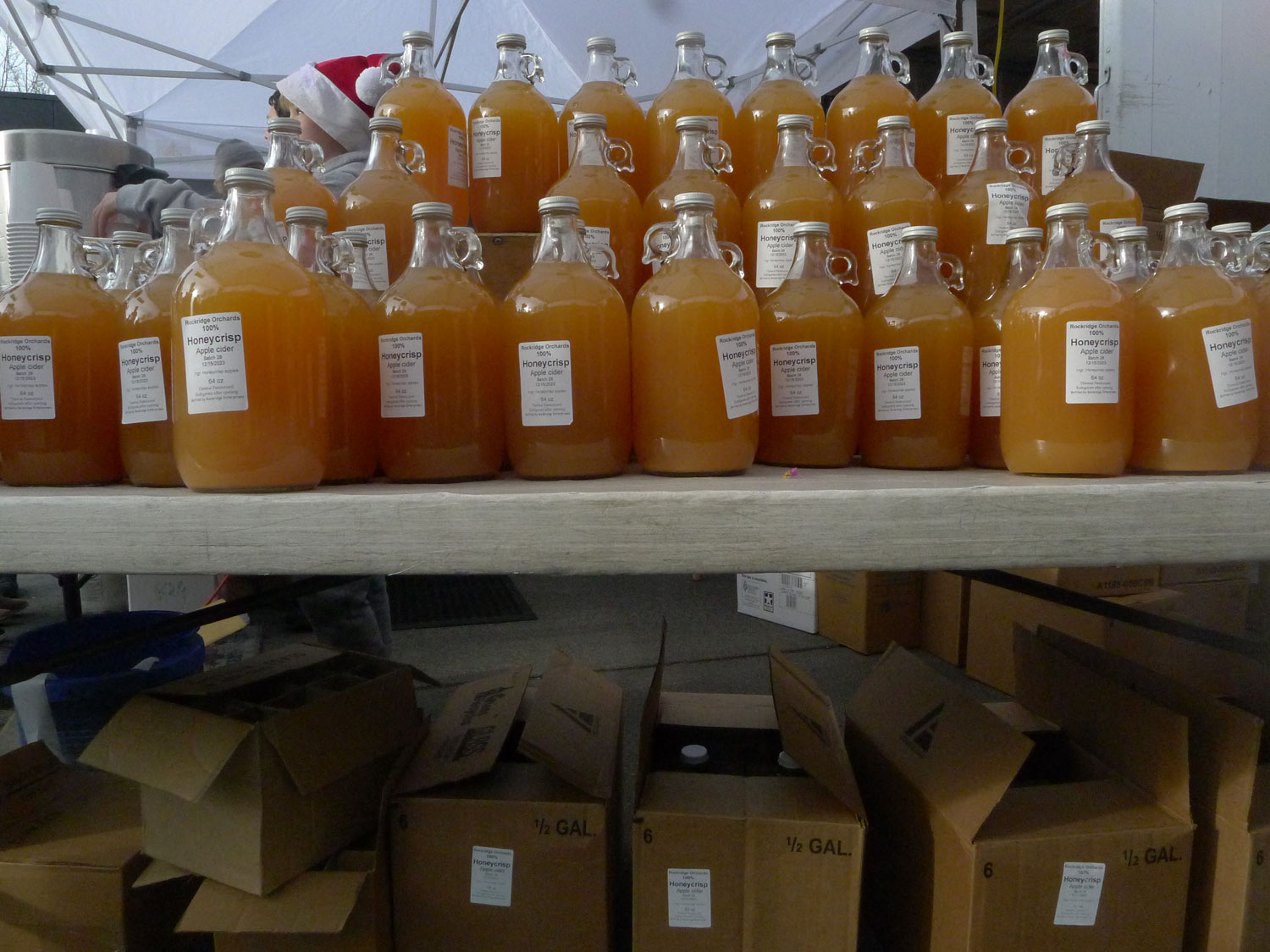 Jars of fresh apple cider stacked on a table