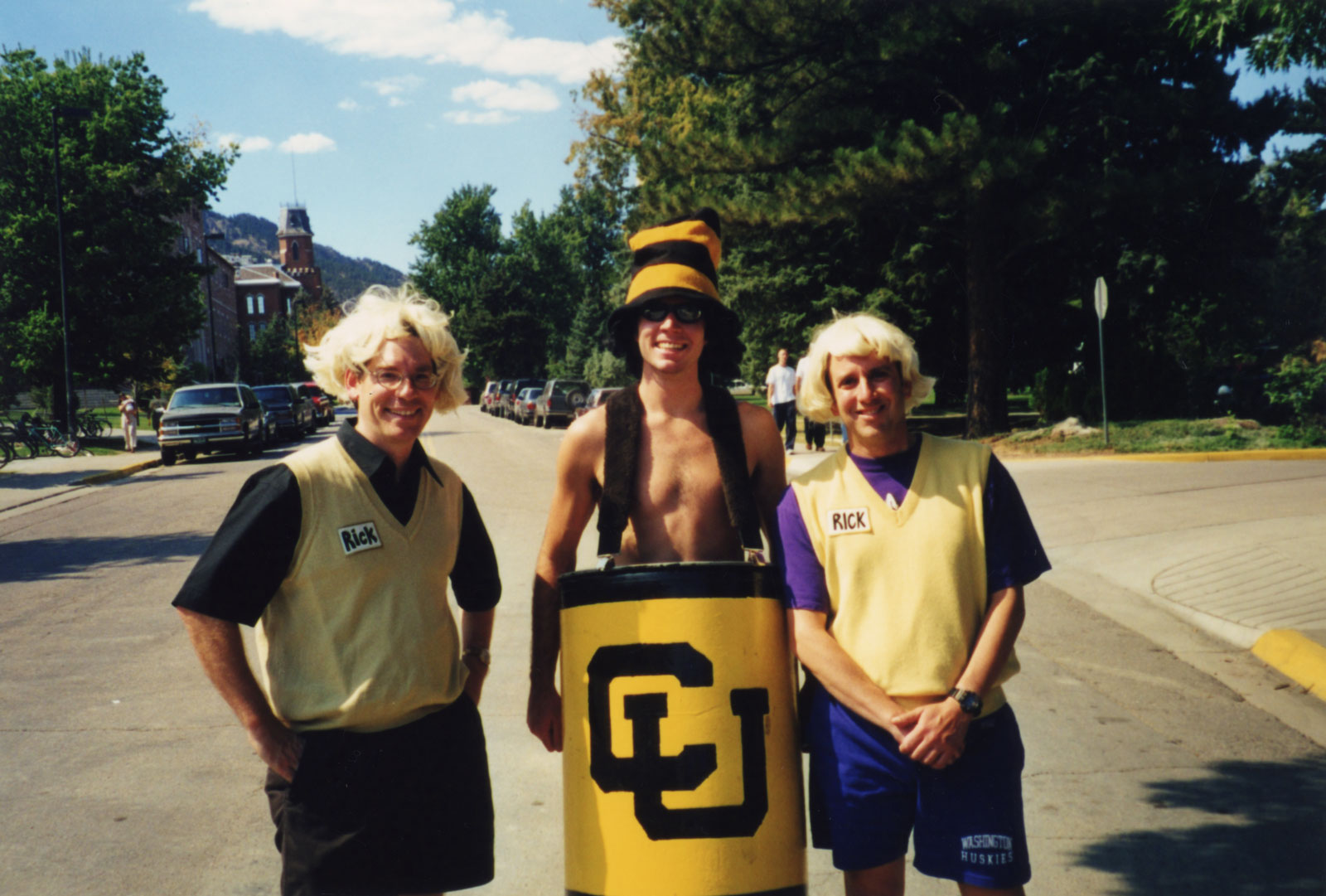 Three men in costumes on a Colorado street.