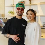 A man and woman pose in their cafe.