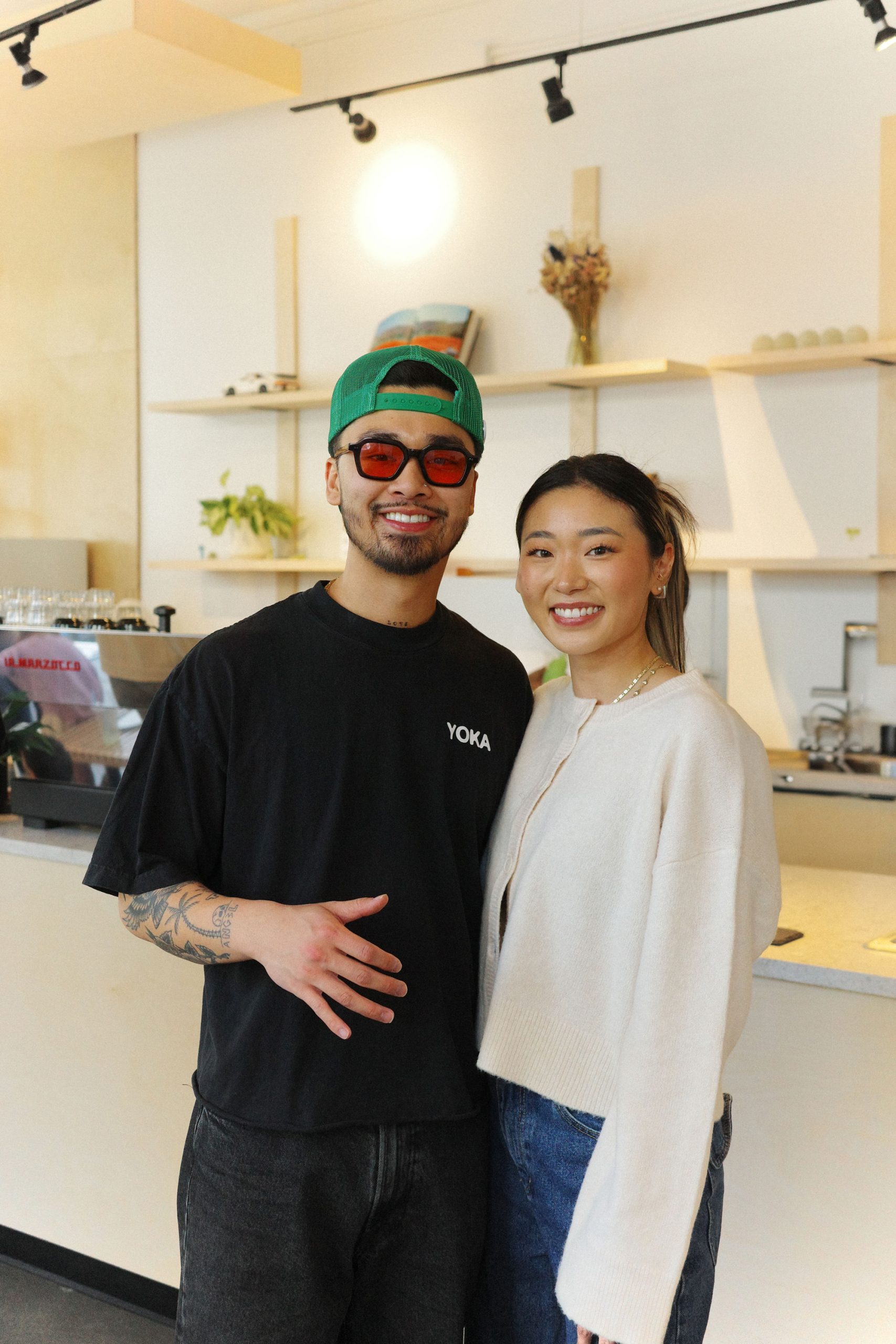 A man and woman pose in their cafe.