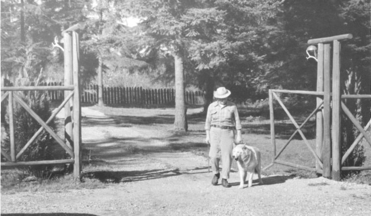 Wasky and his trainer walking through a gate.