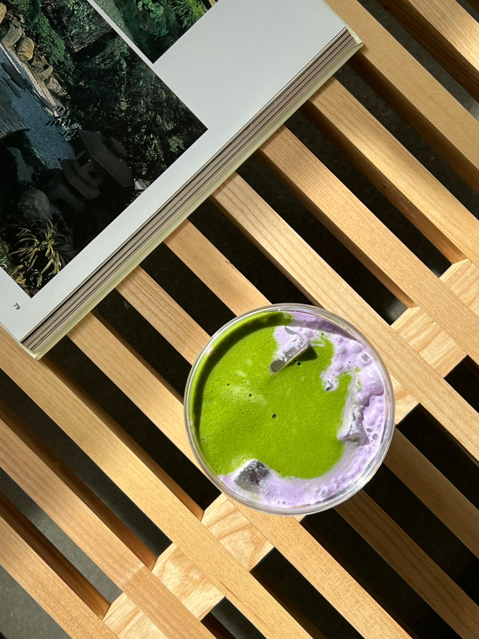 Overhead view of a matcha latte with purple foam.
