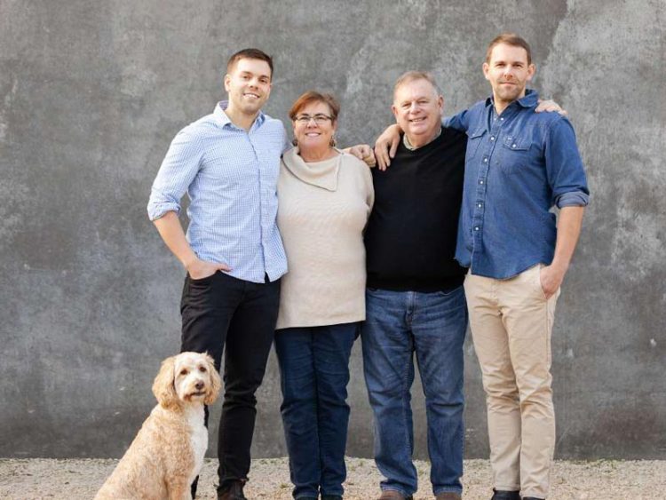 A family, including a dog, two young men and two parents