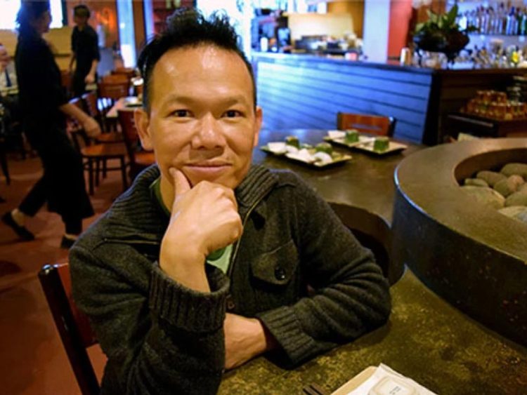 Tam Nguyen sits at a table in his restaurant, Tamarind Tree
